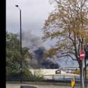 A huge plume of smoke is drifting across the city