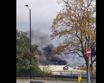 A huge plume of smoke is drifting across the city