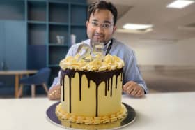 Great British Bake Off winner Dr Rahul Mandal with his showstopper - the official AMRC  25th birthday cake.