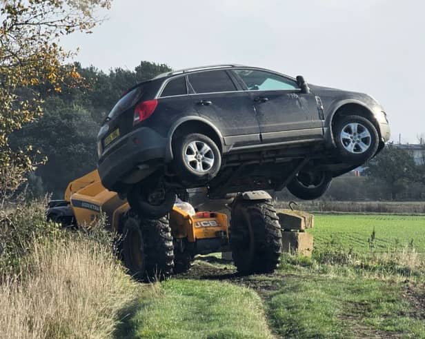 Police removed vehicles from a field.