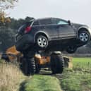Police removed vehicles from a field.