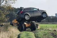 Police removed vehicles from a field.