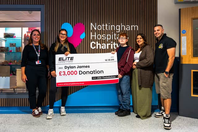 Dylan and family holding donation cheque with Elite Competitions team member and member of staff from Nottingham Childrens Hospital