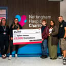 Dylan and family holding donation cheque with Elite Competitions team member and member of staff from Nottingham Childrens Hospital  