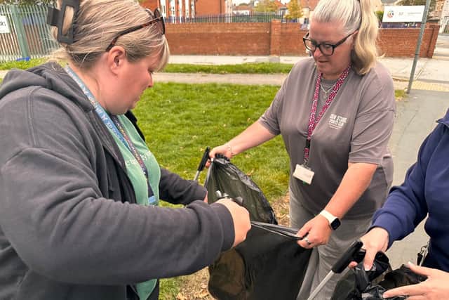 Staff at Carcroft School engaging in acts of service, like litterpicking in the local area