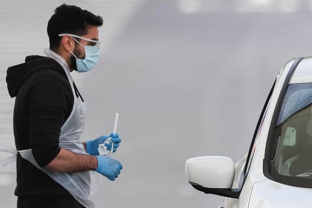 A tester administers a coronavirus test at a testing site near Manchester Airport, as the UK continues in lockdown to help curb the spread of the coronavirus. Photo: PA