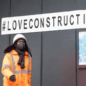 A construction worker wearing a protective face mask at a building site in central London, as Prime Minister Boris Johnson said people who cannot work from home should be "actively encouraged" to return to their jobs. Photo: PA