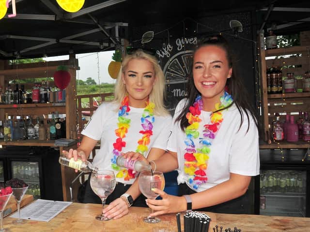 Lydia Woodburn and Jess Willshaw prepare drinks