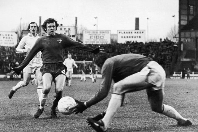 David Harvey stops a shot from Chelsea striker John Hollins during a game at Stamford Bridge in January 1975.