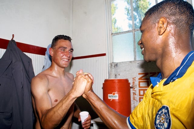 Vinnie Jones and Chris Fairclough celebrate in the dressing room at Dean Court after Leeds secured promotion thanks to a Lee Chapman header.