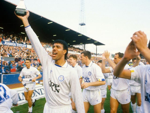 Chris Kamara gets his hands on the trophy.