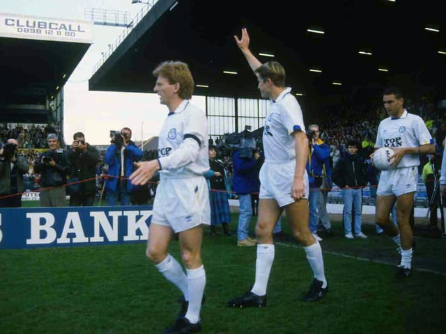 Skipper Gordon Strachan leads out the team as striker Lee Chapman salutes the crowd.