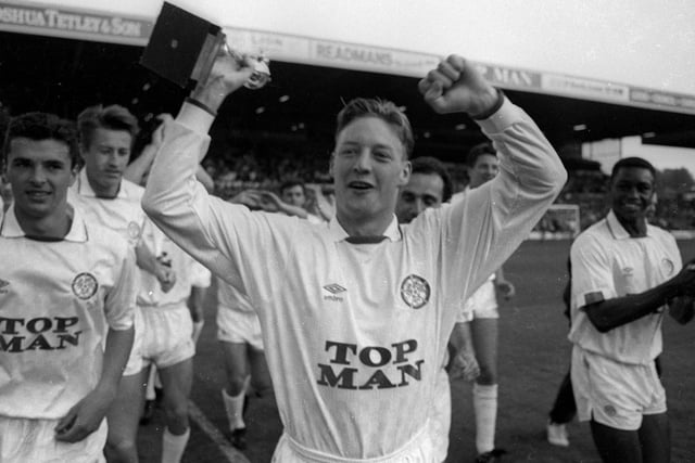 A fresh-faced David Batty gets his hands on the Second Division trophy as the players enjoy a lap of honour.
