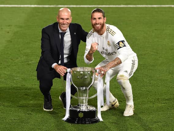 Real Madrid head coach Zinedine Zidane and captain Sergio Ramos pose with the La Liga trophy after Madrid secure the La Liga title during the Liga match between Real Madrid CF and Villarreal CF at Estadio Alfredo Di Stefano on July 16, 2020 in Madrid, Spain. (Photo by Denis Doyle/Getty Images)