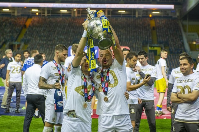 Alioski and Phillips lift the championship trophy at Elland Road.