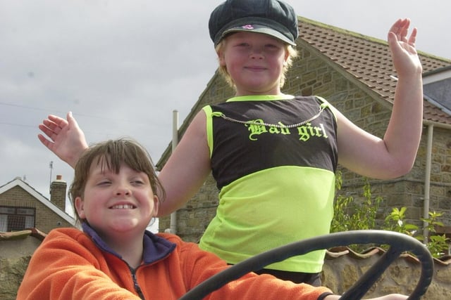 Sisters Leah (left) and Lucy White have a go at driving a tractor.