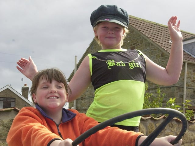 Sisters Leah (left) and Lucy White have a go at driving a tractor.