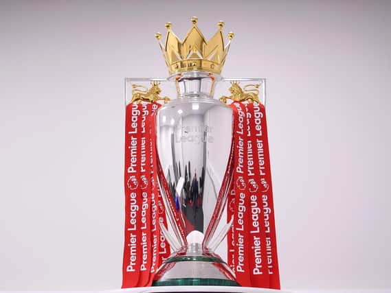 The Premier League Trophy is dressed in Liverpool Red Ribbons.