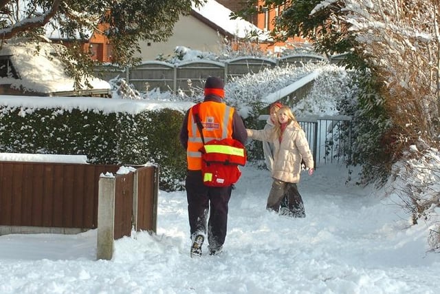 A Postman makes his way through the snow in Lostock Hall