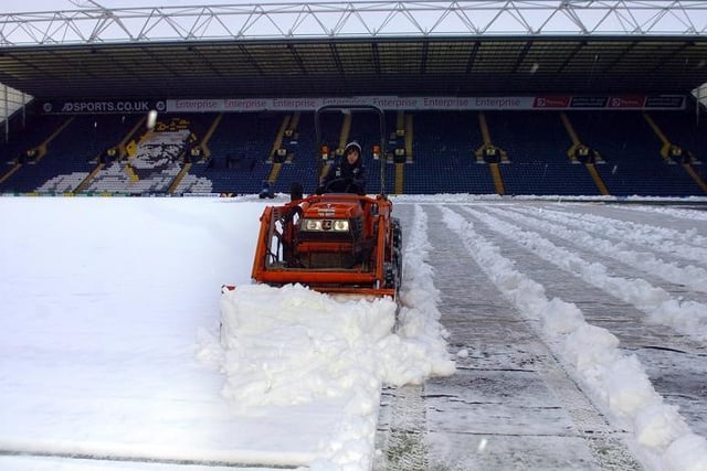 Volunteers and grounds staff snow clearing to get the game on at Deepdale, on December 28th