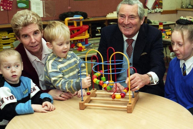 Friday 17th January 1997 - Former governor of the Bank of England, Robin Leigh-Pemberton, then known as Lord Kingsdown, with nursery and school children during his visit to Pemberton Community High School, Montrose Avenue, Wigan.