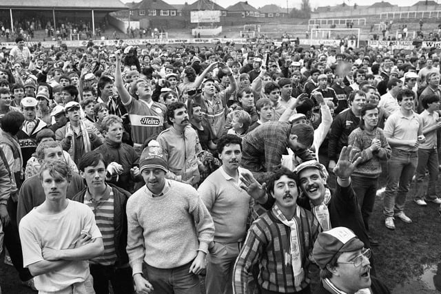 Wigan Athletic fans on the pitch to cheer their team after the final Division 3 match of the 1985/86 season at Springfield Park which Latics won 5-3 on Saturday 3rd of May 1986.
Warren Aspinall scored a hat-trick with Steve Walsh and Graham Barrow getting the other goals.