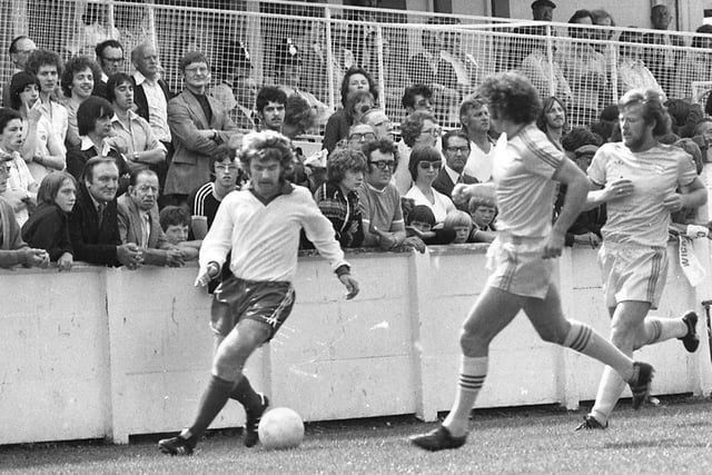 Wigan Athletic winger Alan Crompton watched by spectators, manager Ian McNeill, trainer Kenny Banks and subs Geoff Gay and Neil Davids in Latics friendly match against 1st Division Birmingham City at Springfield Park on Saturday 29th of July 1978 prior to their first season in the Football League.
The game was a 0-0 draw.