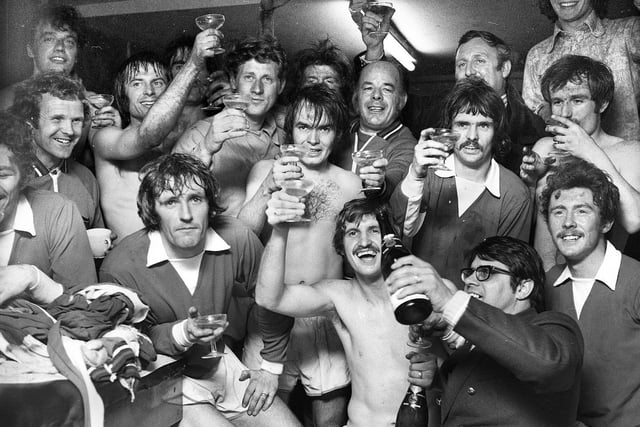 Wigan Athletic secretary Derek Fuller pours the champagne as the team celebrate their 1-0 win against Stafford Rangers in the FA Challenge Trophy semi-final replay on Wednesday 4th of April 1973 at Boundary Park, Oldham.
