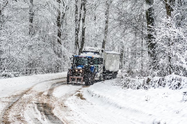 The farmer pulling a lorry along the road with his tractor. Photo: James Hardisty