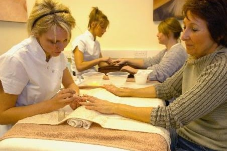 February 2007 and student Danielle Sharp works on the finger nails of Vivien Nichols at Habits, Garforth Community College's hair and beauty in-house training school.