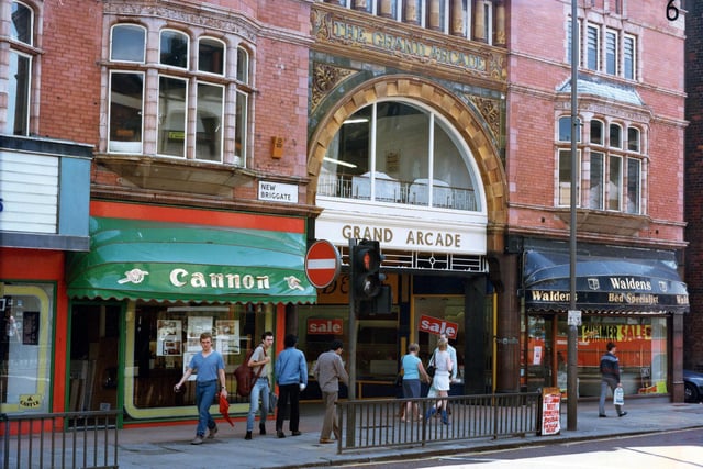 The entrance to the Grand Arcade on New Briggate in July 1985. To the left is Cannon, kitchen and bathroom unites, and to the right Waldens bed specialists. Tower Picture House can be seen on the far left edge of the photo. The cinema was closed earlier in the year in March 1985.