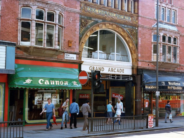 The entrance to the Grand Arcade on New Briggate in July 1985. To the left is Cannon, kitchen and bathroom unites, and to the right Waldens bed specialists. Tower Picture House can be seen on the far left edge of the photo. The cinema was closed earlier in the year in March 1985.