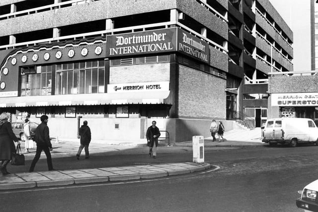 The Merrion Centre from Wade Lane, with the Dortmunder International public house in the centre pictured in February 1985. The entrance to the Merrion Centre Superstore is on the right.