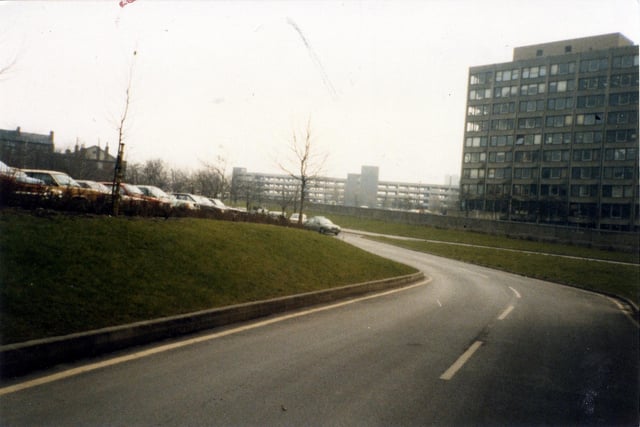 A view across the Inner Ring Road to the buildings of Leeds Polytechnic (now Leeds Metropolitan University) on the right, taken from Vernon Road. A multi-storey car park on New Woodhouse Lane is seen in the centre background, while an outdoor car park is on the left.