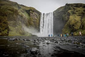 ICELAND: Tourists walk around Skogafoss waterfall. Photo: Getty Images