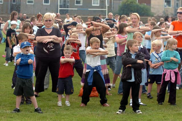 Participants in the world record attempt for the most people doing the haka and the Ch- Cha Slide at Featherstone Rovers ground.
