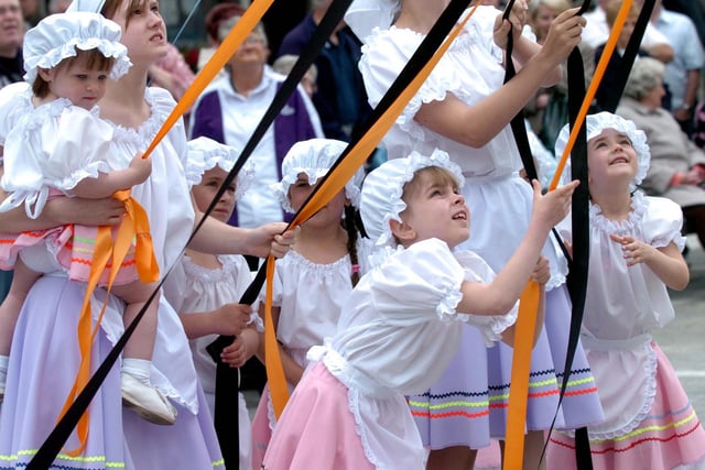 Children from the Castleford Dance Troupe dance round the Maypole, in the new Henry Moore Square, Castleford.