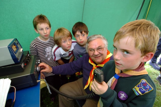Scouts, cubs and beavers from the Wakefield, Pontefract and Castleford area  at the Scouting Sunrise Camp at Nostell Priory to celebrate 100 years of scouting. Cub Sam Holley, eight, talking on the radio to the World Scouts headquarters in Geneva, watched by scout treasurer John Carter and cubs, from the left, Ben Arnold, James Battye and Ben Askew.