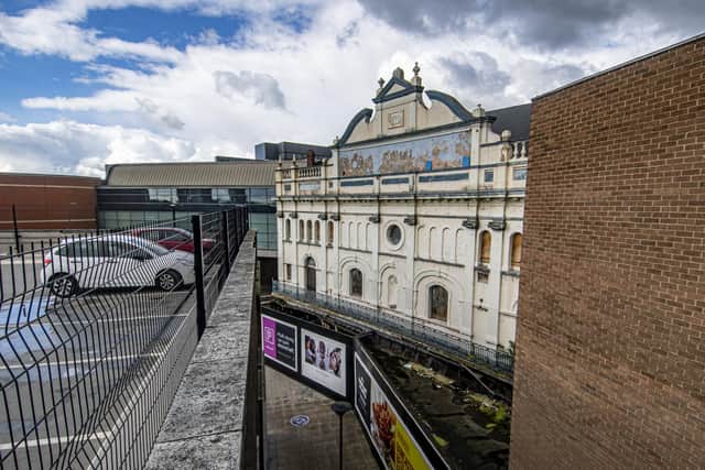 The theatre's grand frontage is now 'hemmed in' by a shopping centre and transport interchange