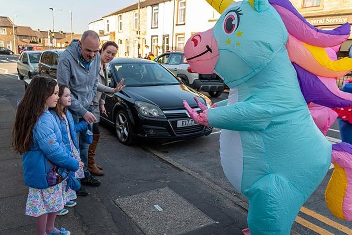 These two children were greeted by a unicorn as the parade made its way through Rosegrove