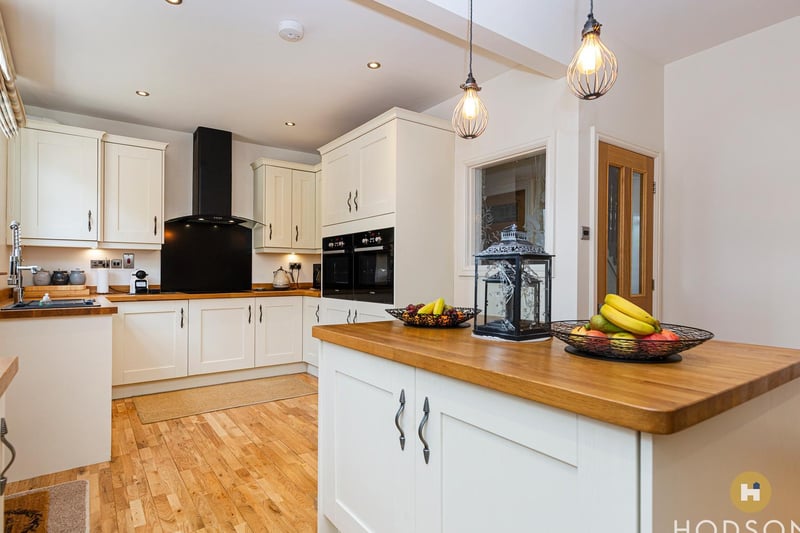 The lovely spacious kitchen, with central island, has multiple units.