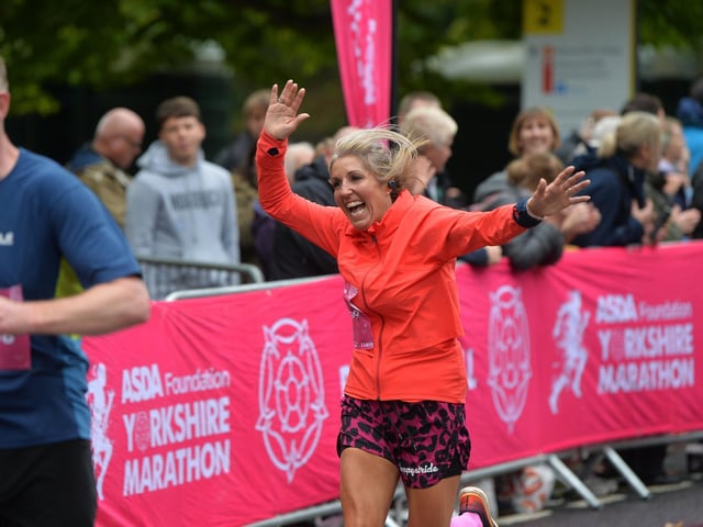 A runner celebrates finishing