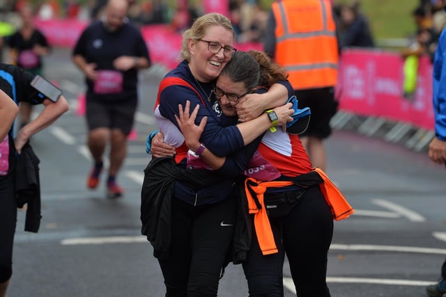 Women embrace at the finish line