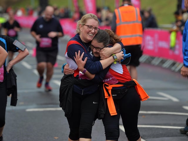Women embrace at the finish line