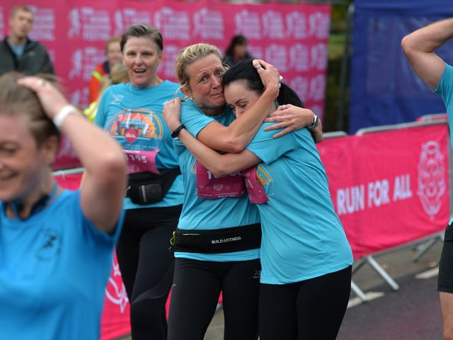 A charity team celebrate finishing
