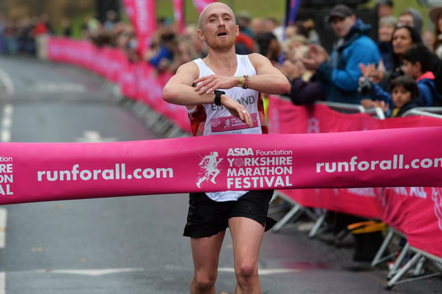 England age-group runner Tom Charles crosses the finish line first