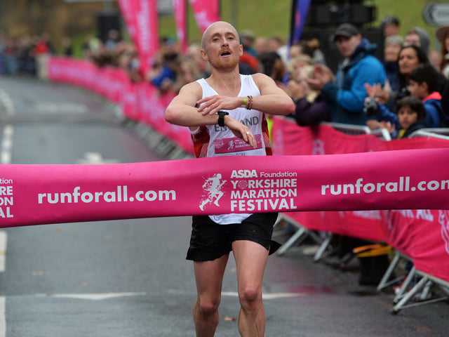 England age-group runner Tom Charles crosses the finish line first