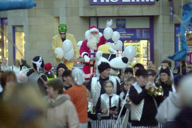 Father Christmas arrives through the busy streets of Lancaster to switch on the lights on Sunday 2001.