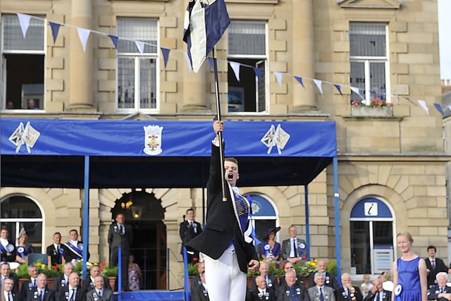 Calum Thomson holding Kelso's banner aloft.