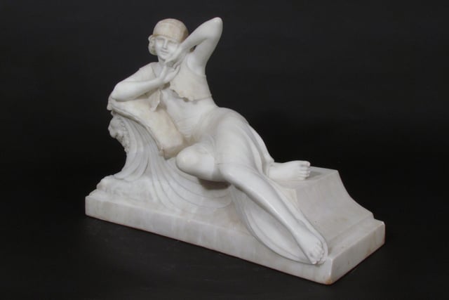 Reclining lady, a signed circa 1920 white alabaster figure of a reclining maiden on a couch supported by two winged lions, by Altieri, priced at £3,200 with Garret & Hurst.